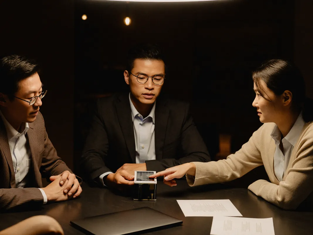 AI concept image: a sales team reviewing a solar cell sample and a battery module